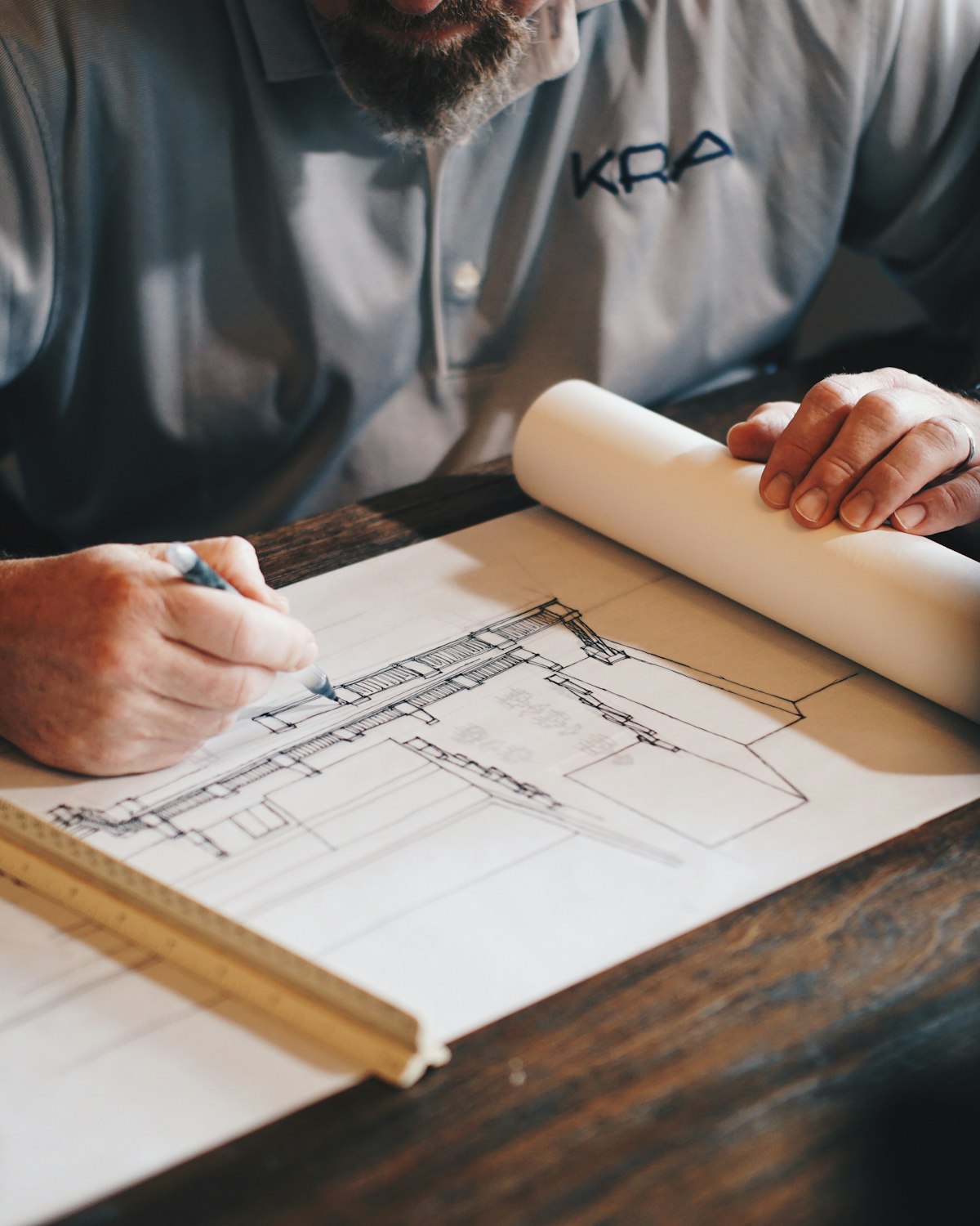 MCRAU builder reviewing detail drawings on a Perth construction site